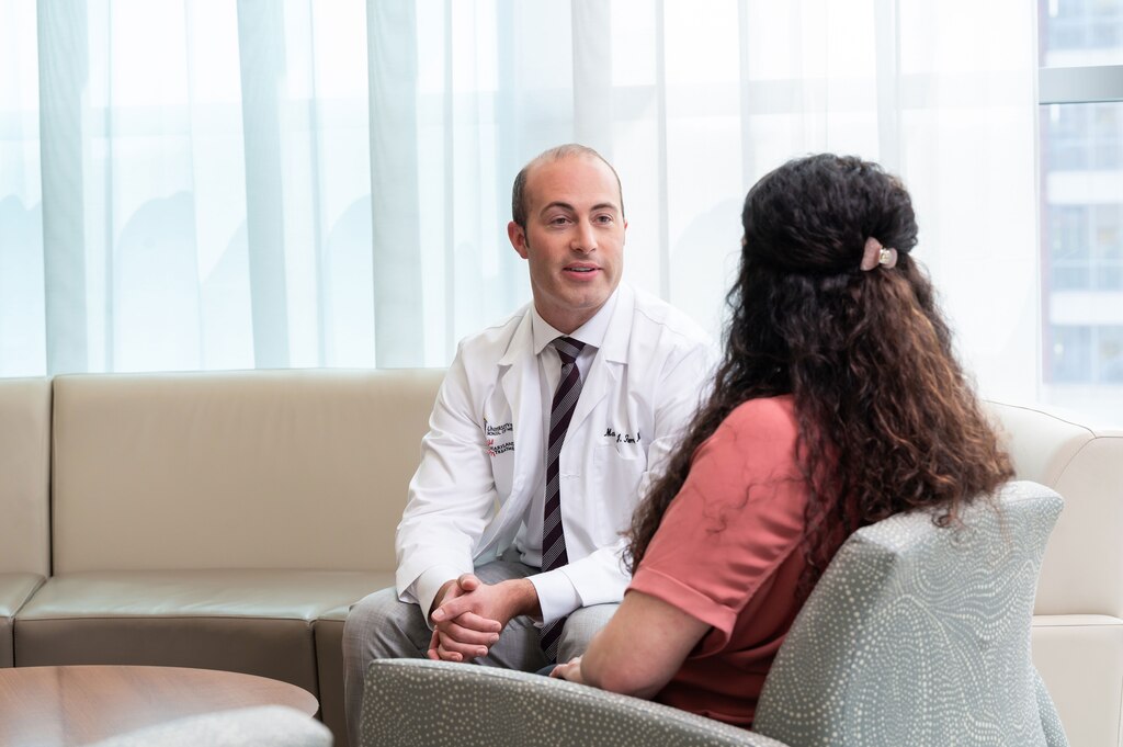 Dr. Ferris discussing proton therapy treatment with patient. (Photo credit: Whitney Wasson)