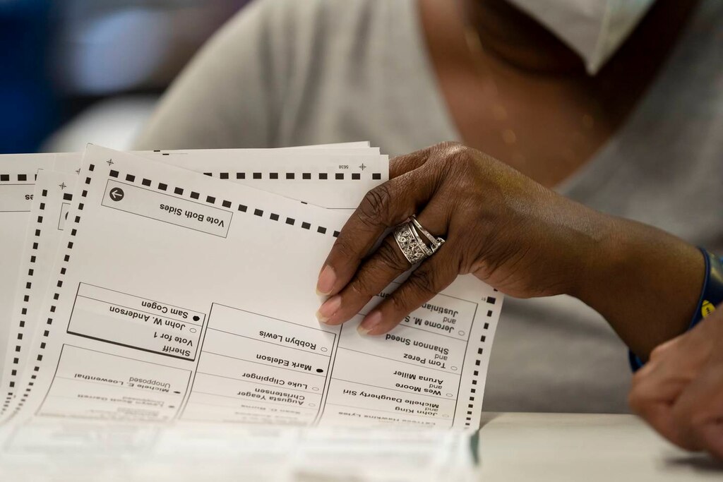 A ballot counter sorts through the mail-in ballots.