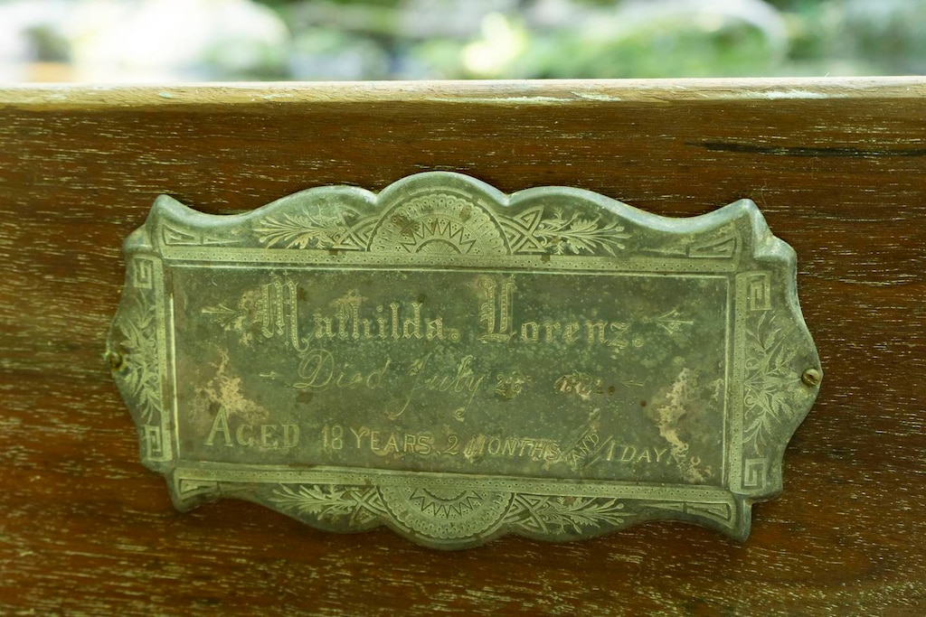 The engraving on the side of the casket reads: "Mathilda Lorenz. Died July 26, 1882. Aged 18 years, 2 months and 1 day." Stephanie's testing quotes and apostrophes.