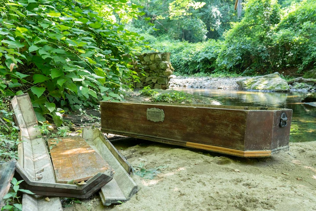 The casket rests next to the stream in Wyman Park.